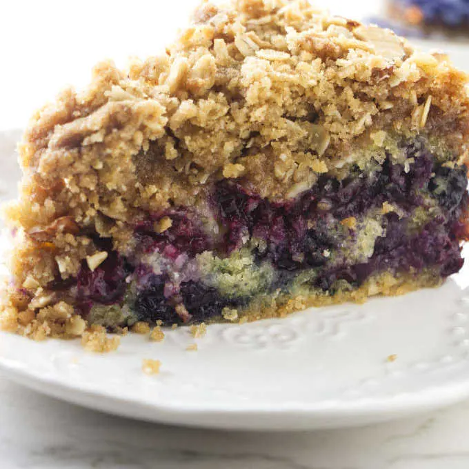 A slice of blueberry buckle coffee cake on a dessert plate.