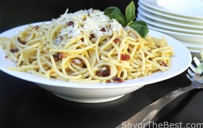 A plate of pasta with cheese on top. 