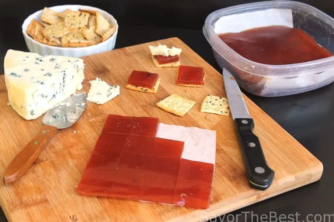 Pear Paste on a cutting board with crackers and cheese