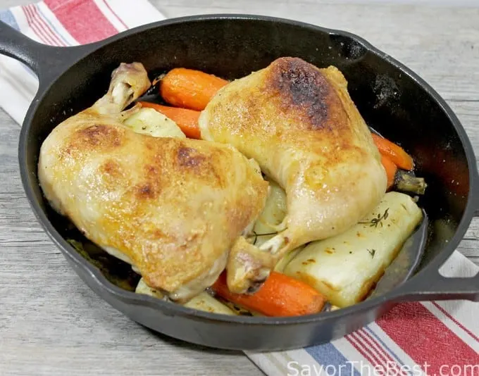 Chicken quarters roasted in a cast iron skillet. 