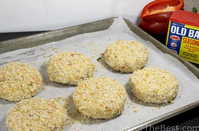 Panko breaded crab cakes on a baking tray.