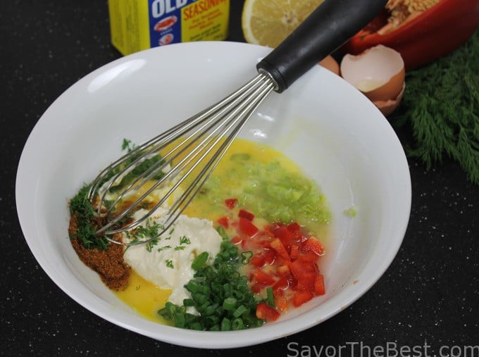 Combining filling ingredients for crab cakes. 