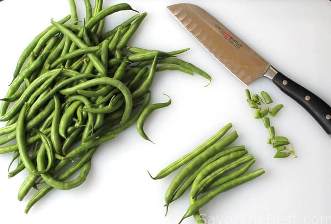 Cutting the ends off fresh green beans. 
