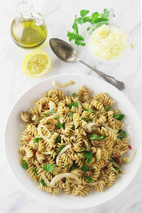 Pasta with Fennel and Mushrooms in a serving dish next to a spoon.