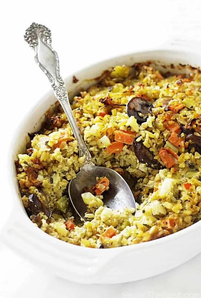 Freekeh stuffing in a cassrole dish with a spoon. 