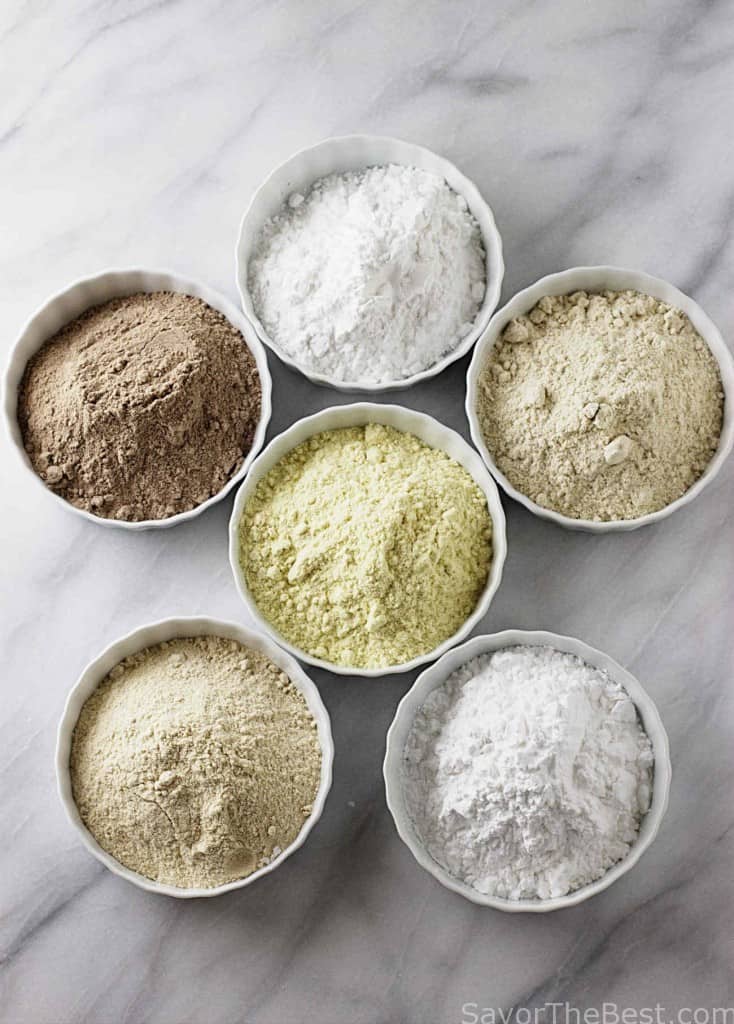 Six bowls filled with ancient grains to use as the ingredients for whole grain gluten free flour. 