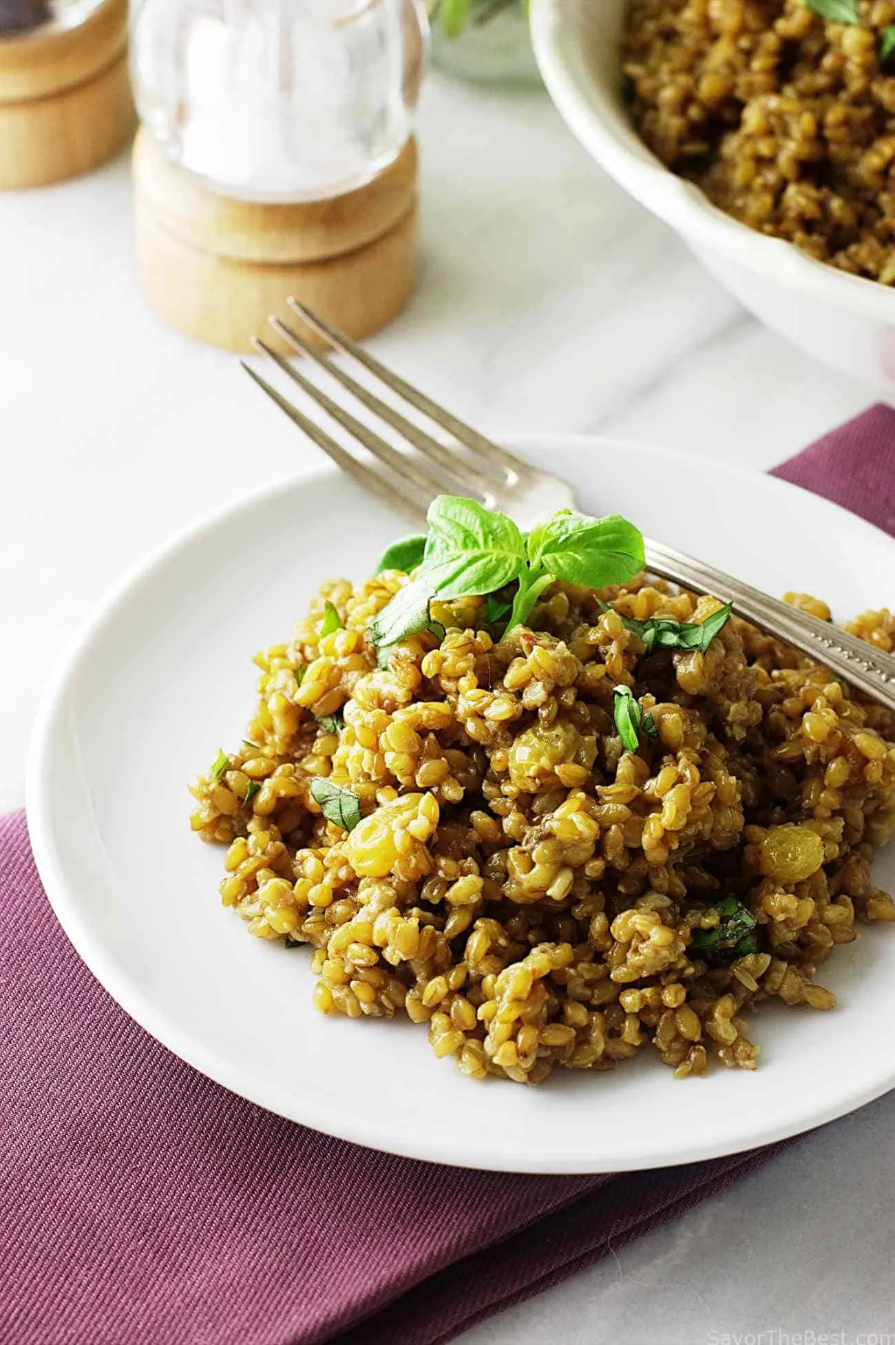 Serving of einkorn risotto on a white plate