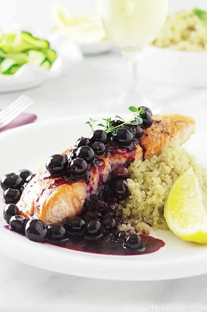 A salmon fillet topped with blueberry sauce. 