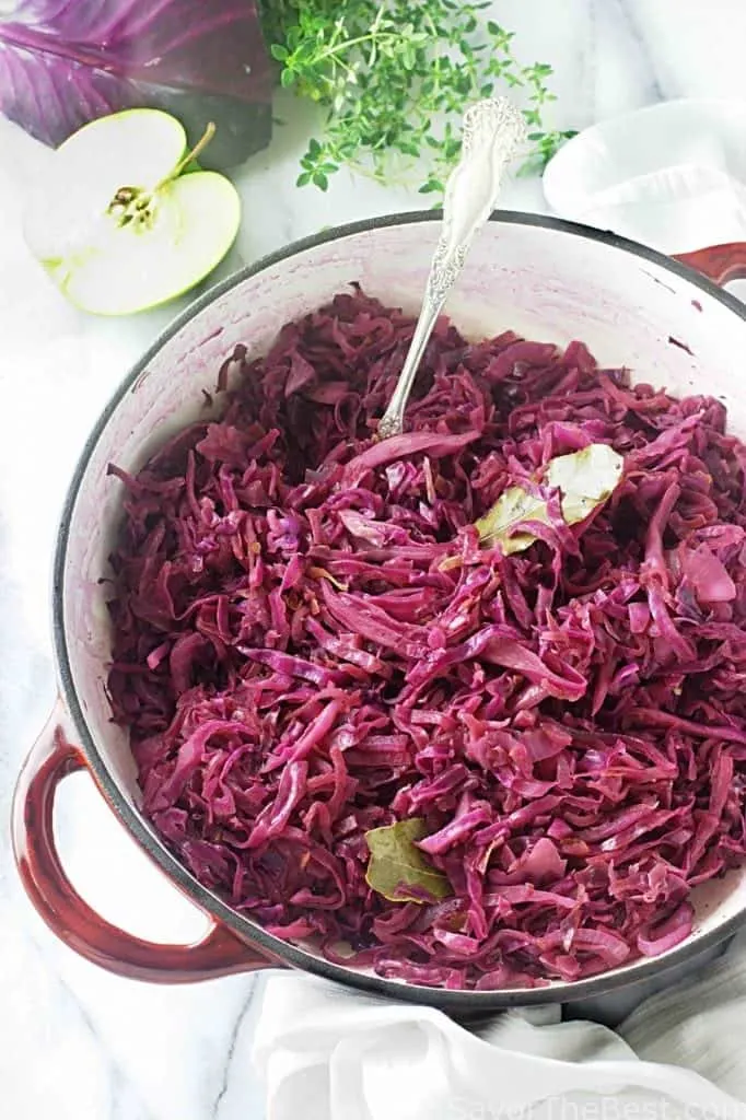 Rotkohl in a Dutch oven pot with a serving spoon. 