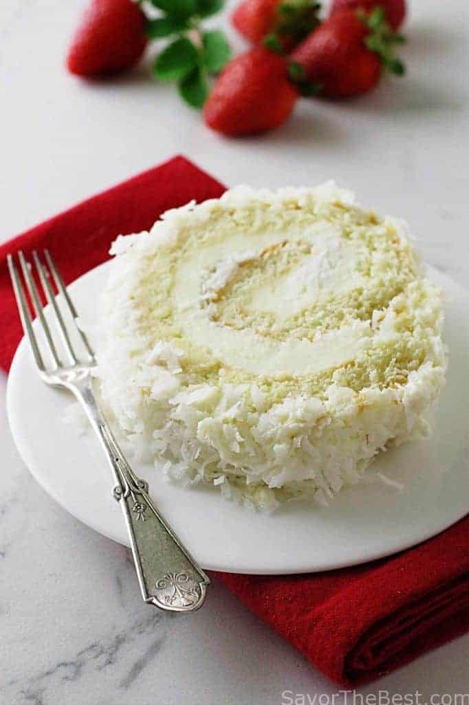 Close up photo of a Coconut Cake Roll showing the swirl of cake and frosting.