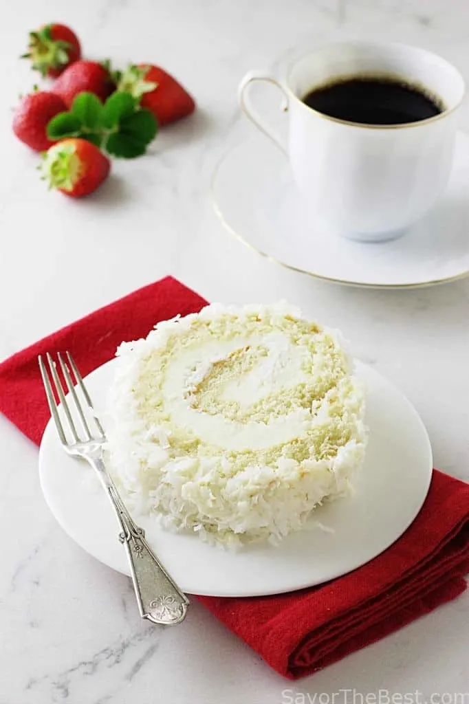 A slice of Coconut Cake Roll and a cup of coffee