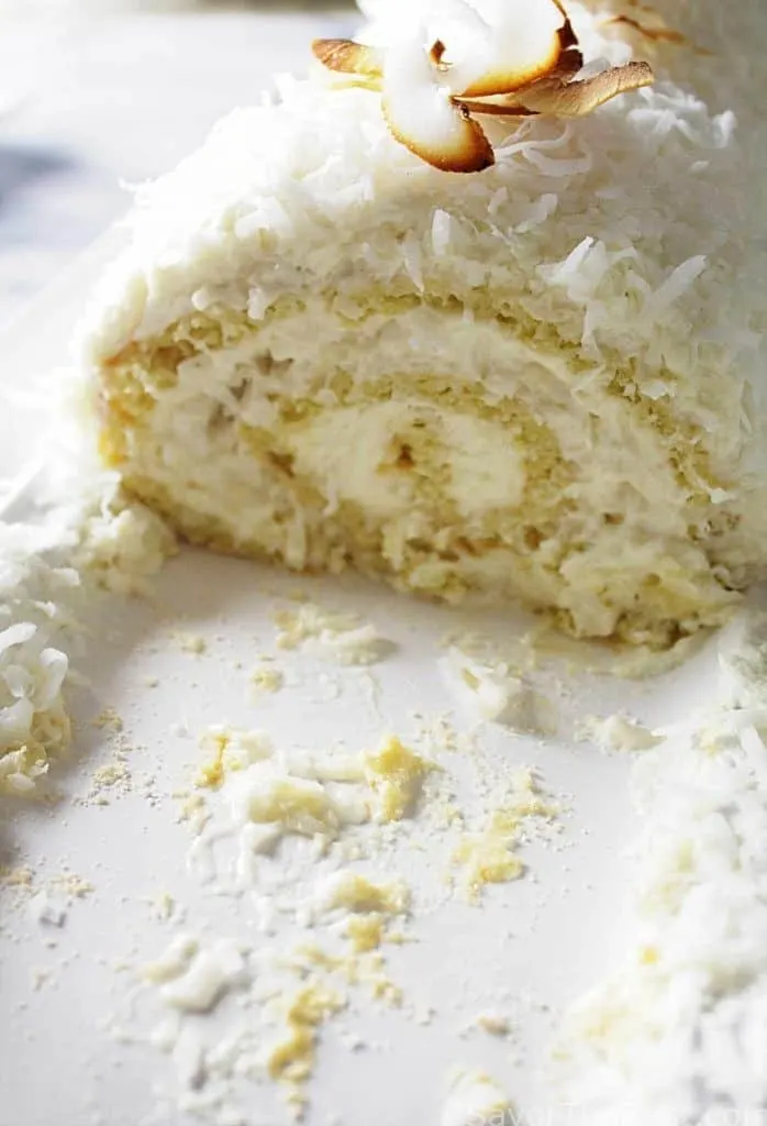 A coconut cake roll with toasted coconut garnish. 