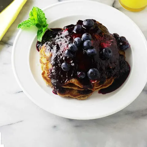 A stack of whole wheat einkorn blueberry pancakes.