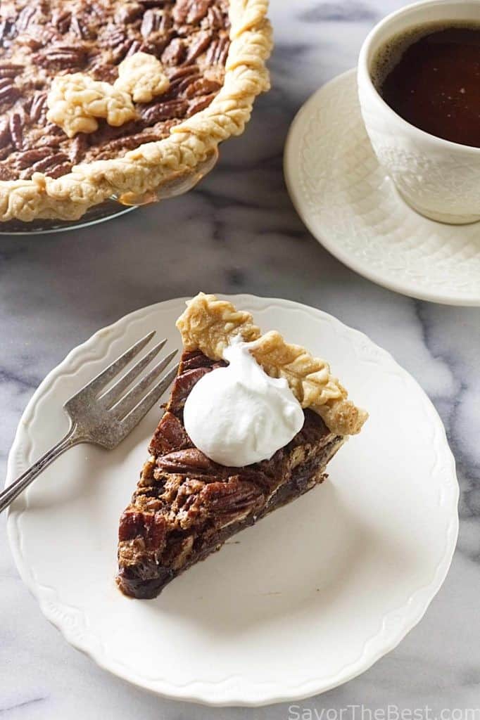 A slice of pie with whipped cream on top.