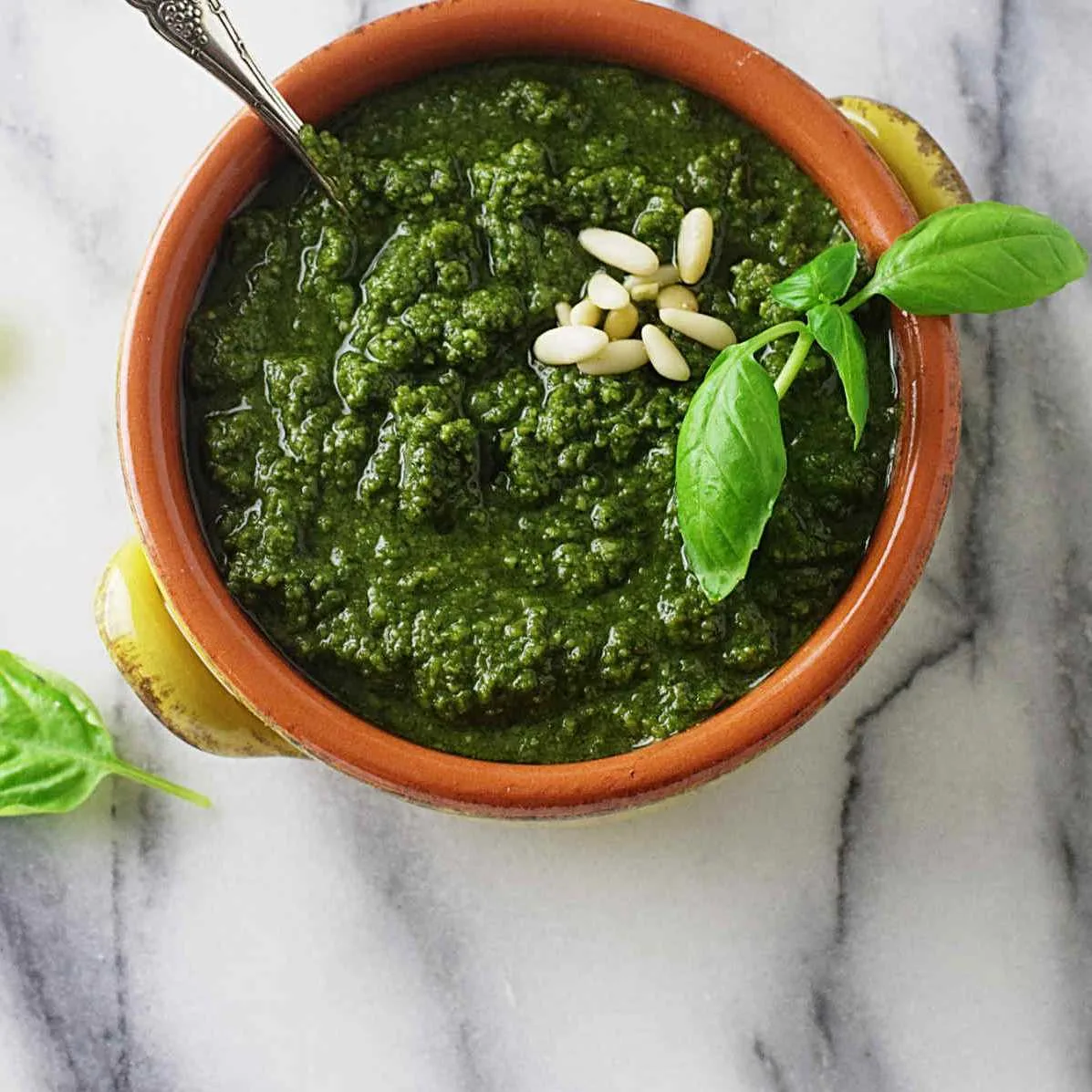 A serving dish filled with pesto.