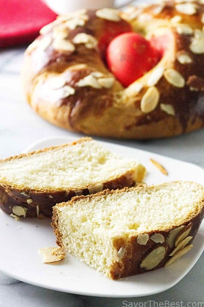 Slices of bread with a larger loaf in the background. 