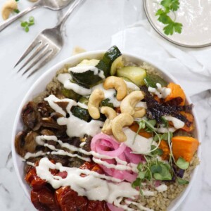 Roasted veggie quinoa bowl with tahini cashew sauce