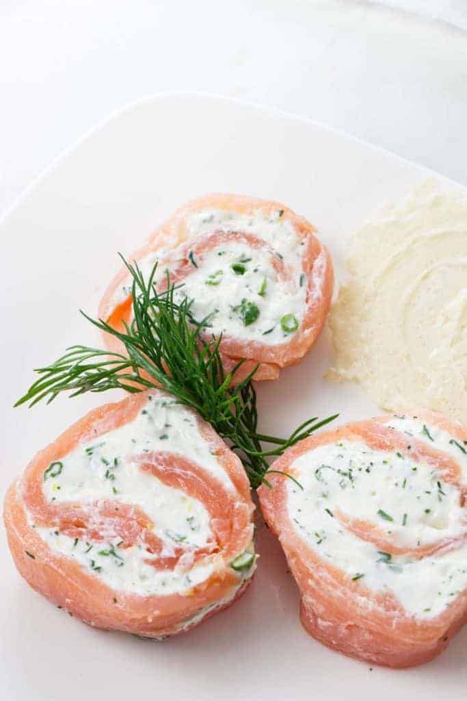 Salmon pinwheel appetizers on a plate.