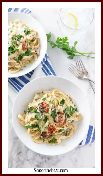Fettuccini pasta is combined with roasted tomatoes and spinach then smothered in a creamy, smooth cashew cream sauce.