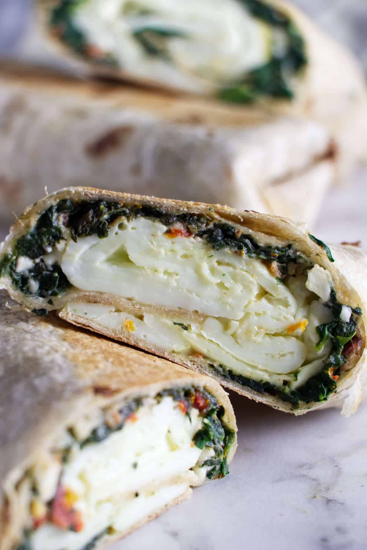 Starbucks Spinach and Feta Breakfast Wraps sliced in half. 