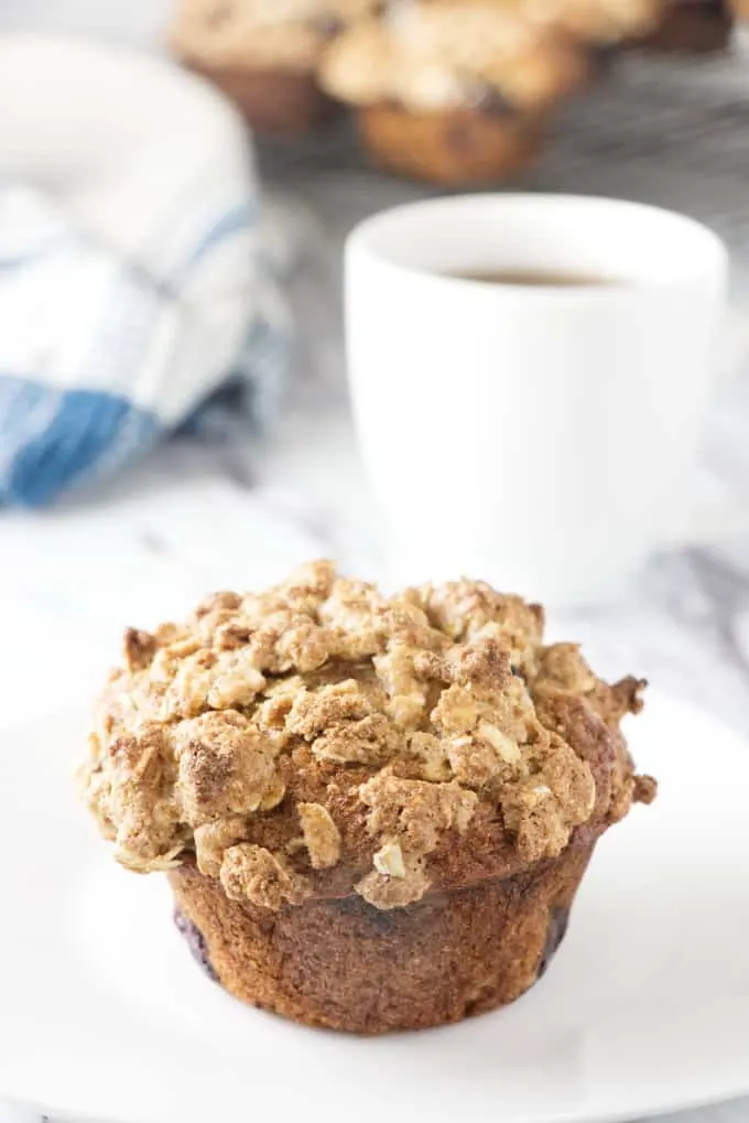 A healthy banana blueberry muffin and a cup of coffee