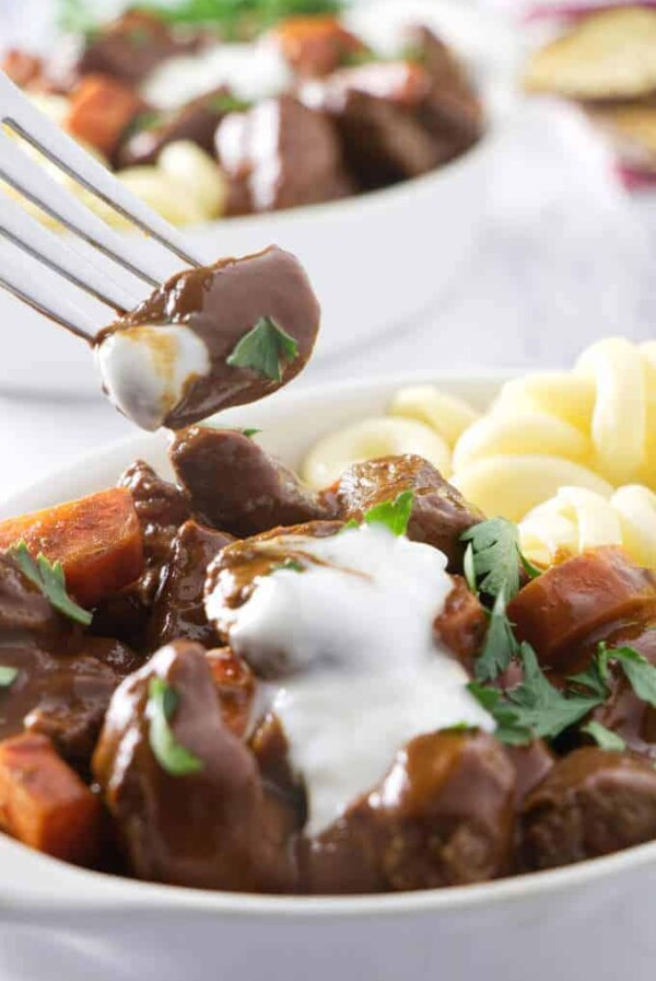 Taking a bite of a tender chunk of venison goulash