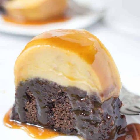 Slice of chocoflan cake covered in caramel syrup