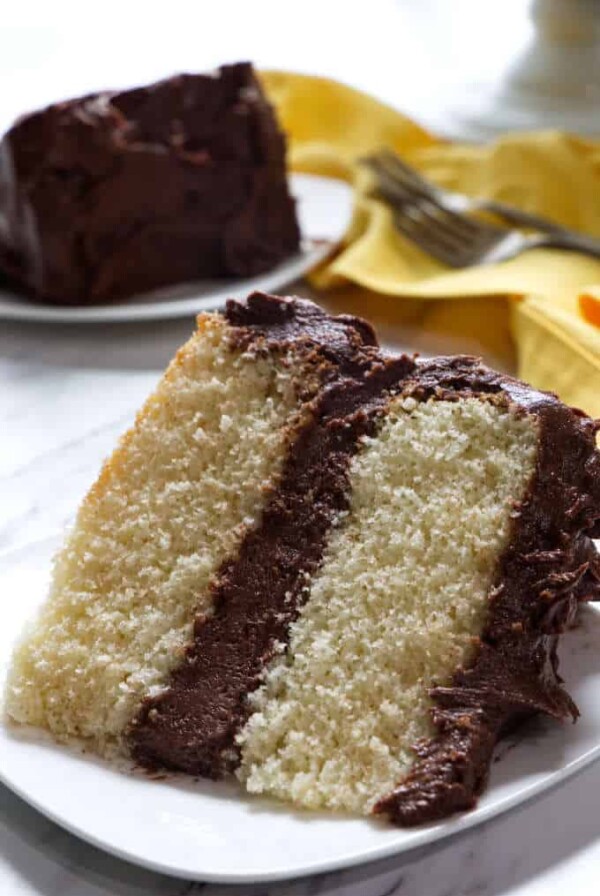 slice of yellow cake with chocolate frosting