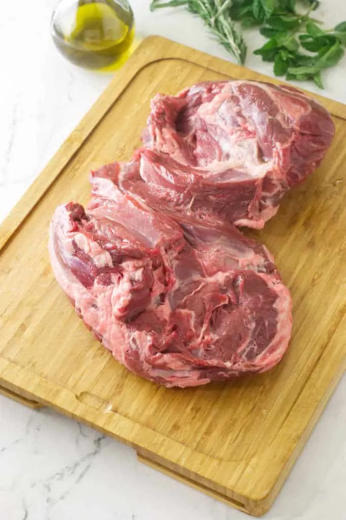 raw piece of lamb on a cutting board