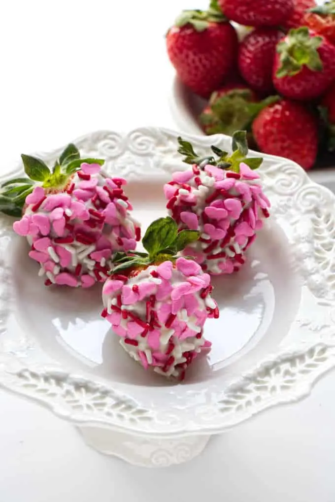 White chocolate covered strawberries covered in pink heart sprinkles
