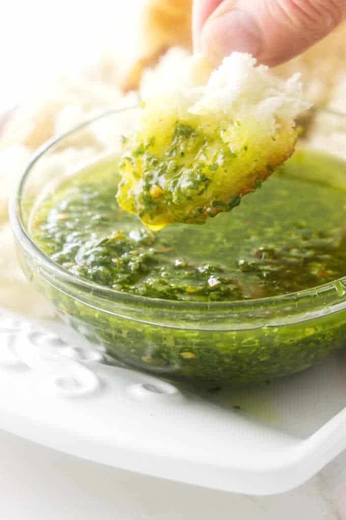 bread being dipped into olive oil dip