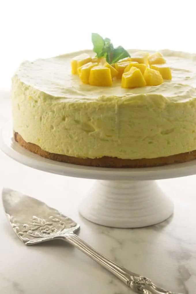 Mango Mousse Cake on a cake stand