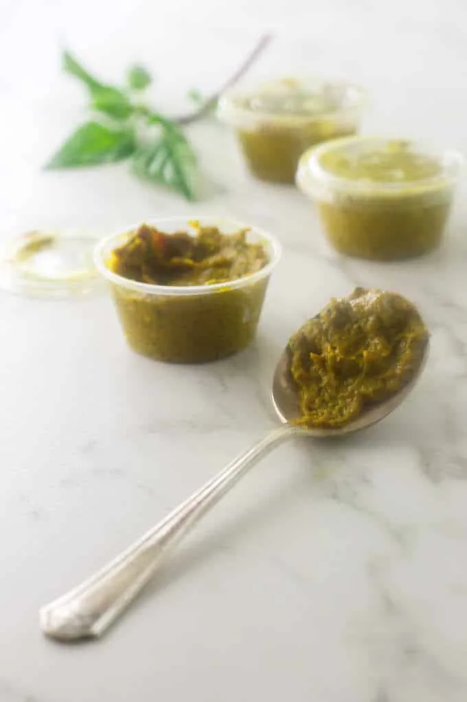 A spoon and three containers of Thai Yellow Curry Paste 