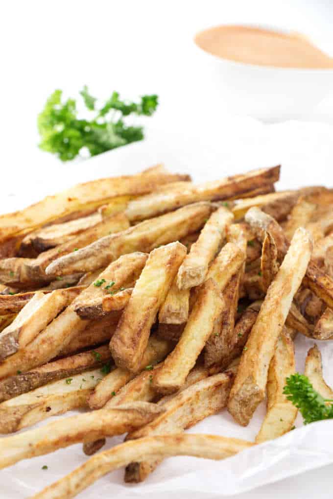 air fried French fries with sauce in the background