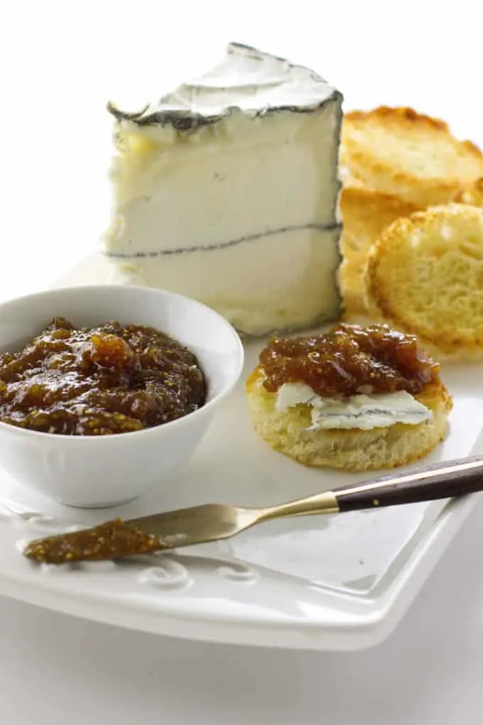 fig jam with cheese and bread on a plate
