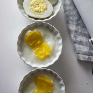 hard medium and soft cooked sous vide eggs in small white bowls