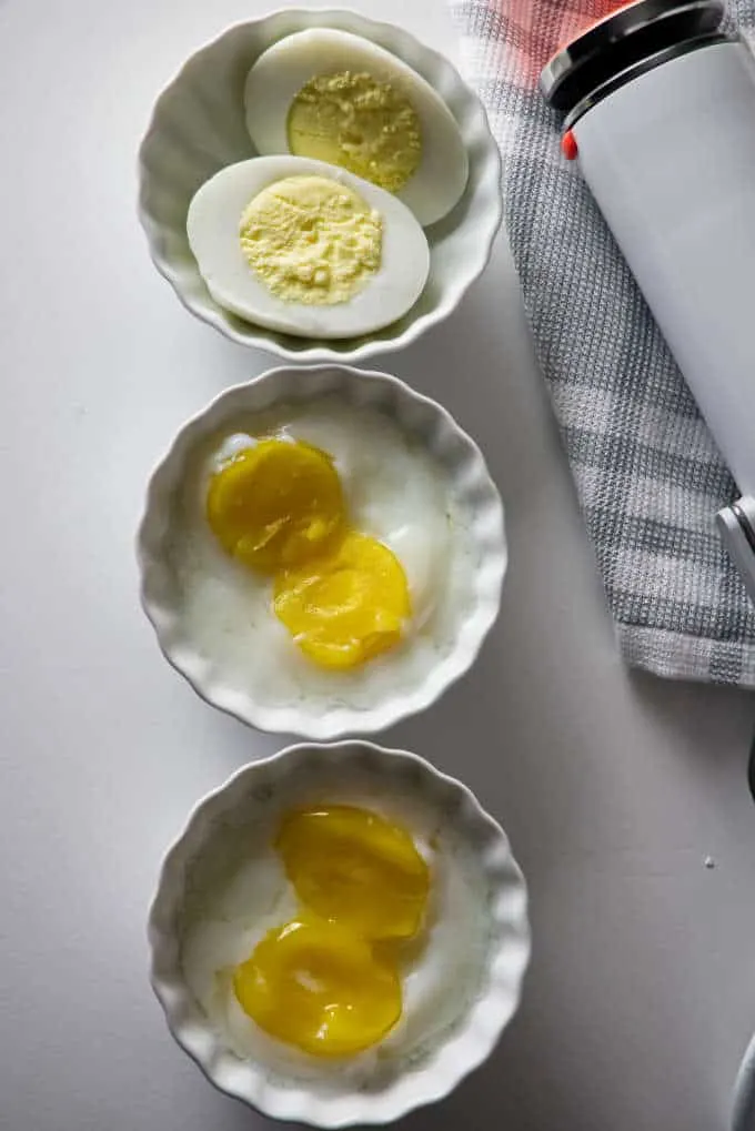 hard medium and soft cooked sous vide eggs in small white bowls
