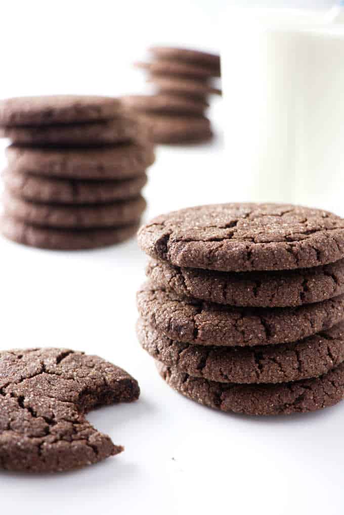 three stacks of sugar cookies and a glass of milk