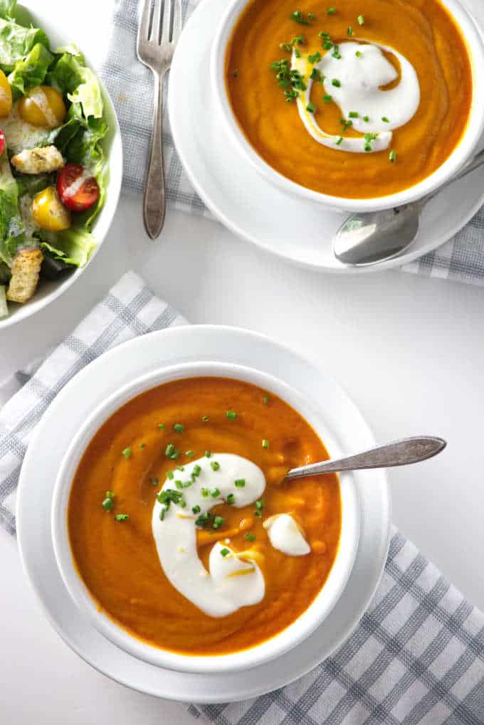 overhead view of two bowls of carrot soup