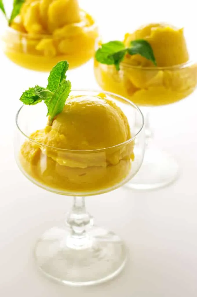 3 glasses with scoops of mango sorbet