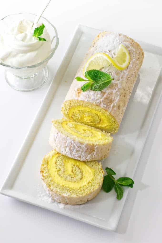 Lemon cake roll on sliced on a serving platter