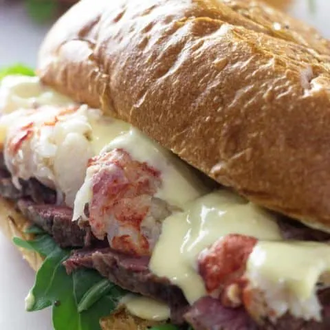 close up of steak and lobster sandwich