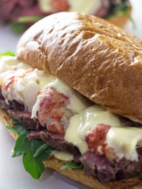 close up of steak and lobster sandwich