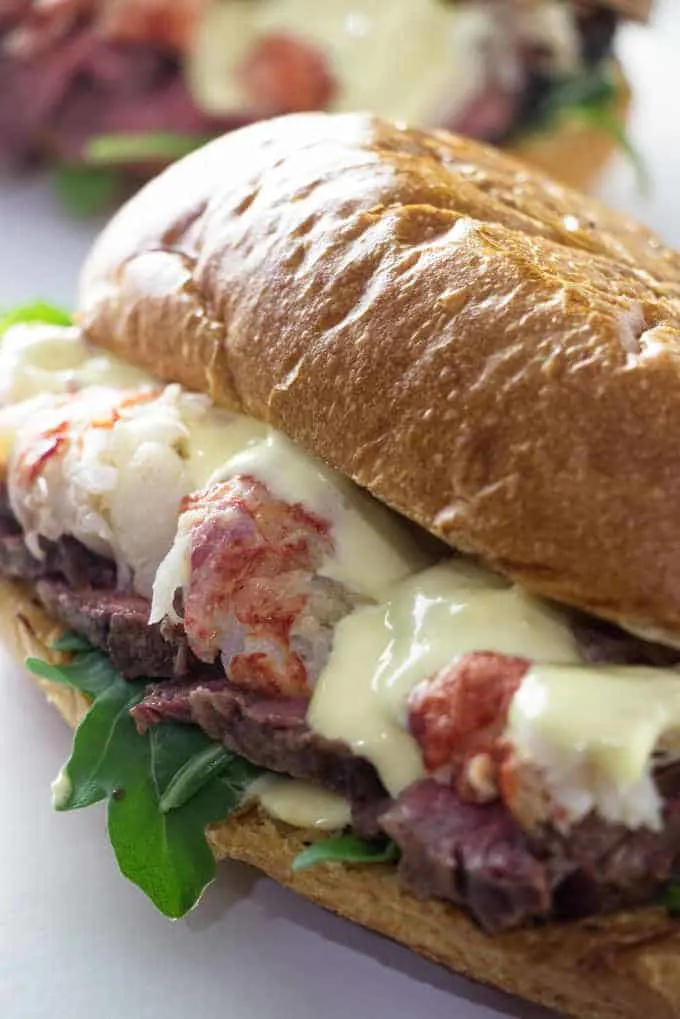 close up of steak and lobster sandwich