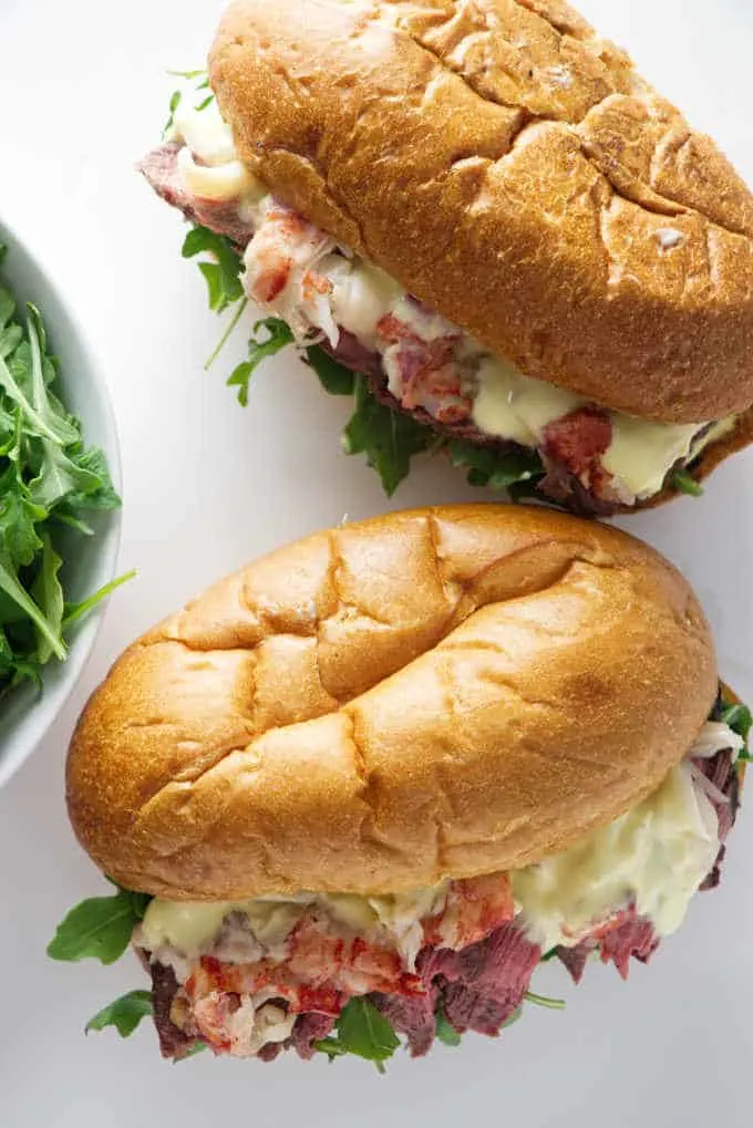 overhead shot of two steak and lobster sandwiches