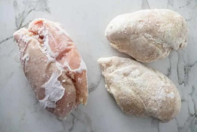 Chicken breasts frozen in a large clump next to chicken breast frozen individually