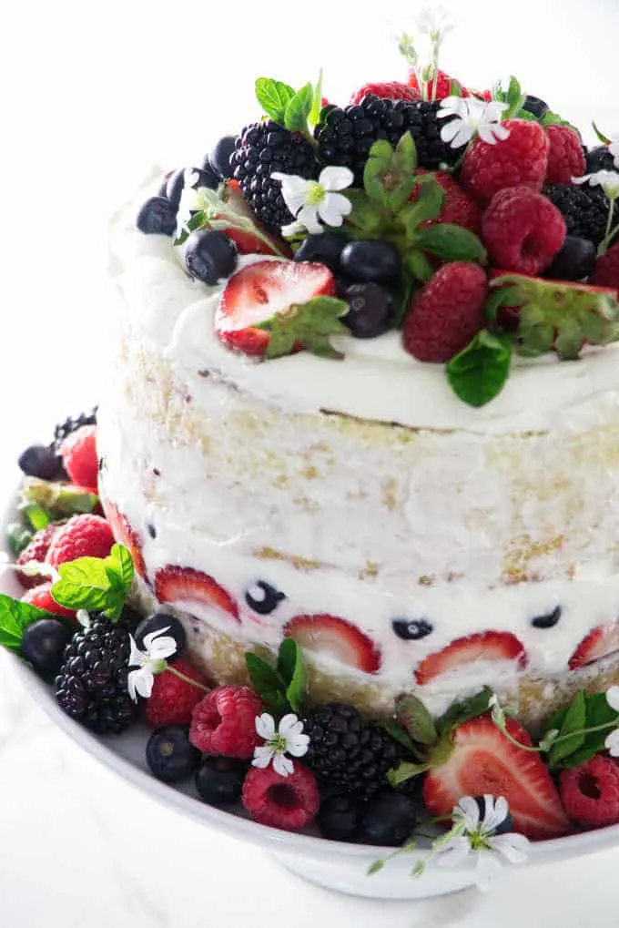 naked cake with berries on a cake plate