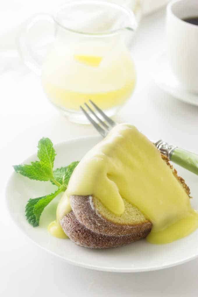 Close up of lemon bundt cake with creamy lemon dessert sauce
