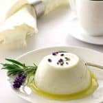 Serving of lavender panna cotta with lemon syrup