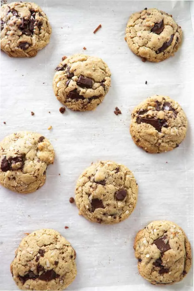 overhead picture of tahini chocolate chunk cookies cooling on a baking sheet